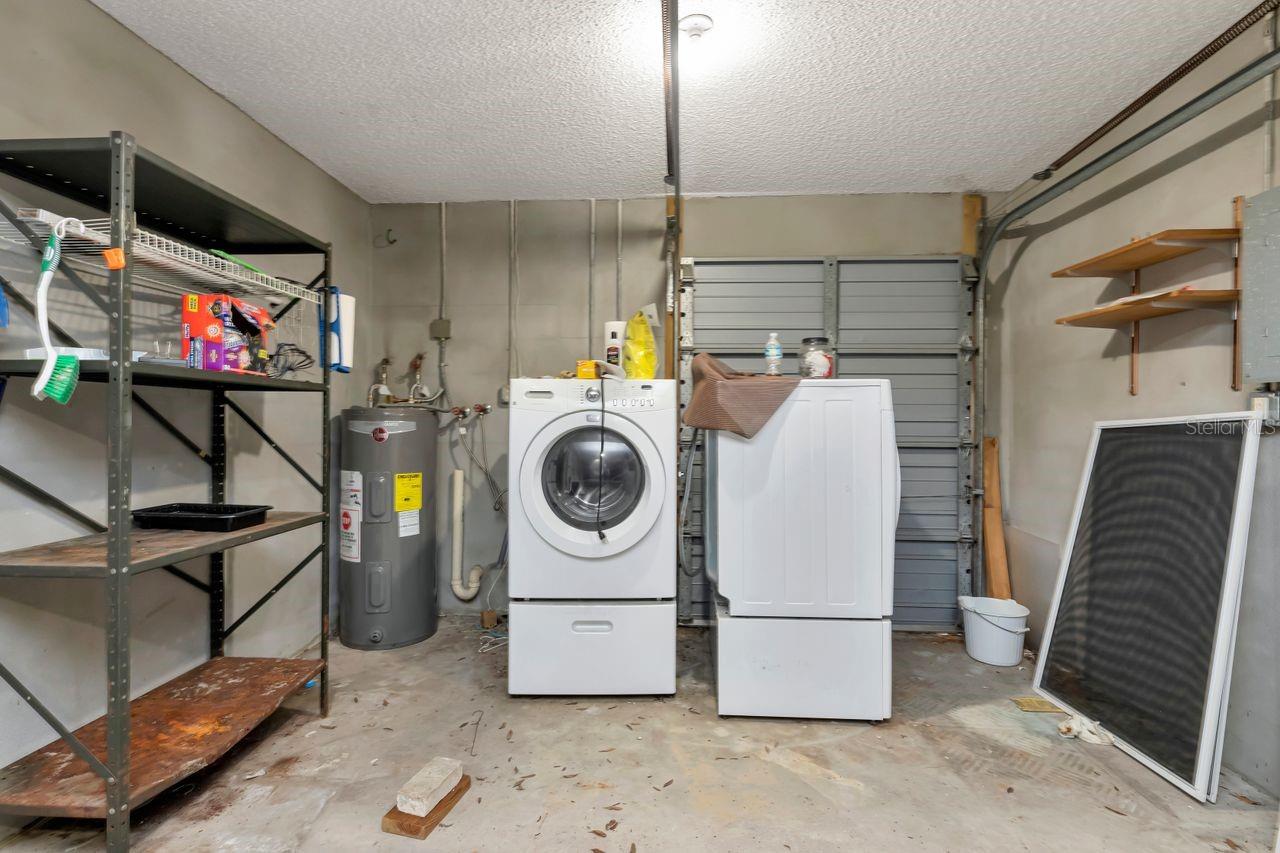 Laundry located in garage with rear access to back of property