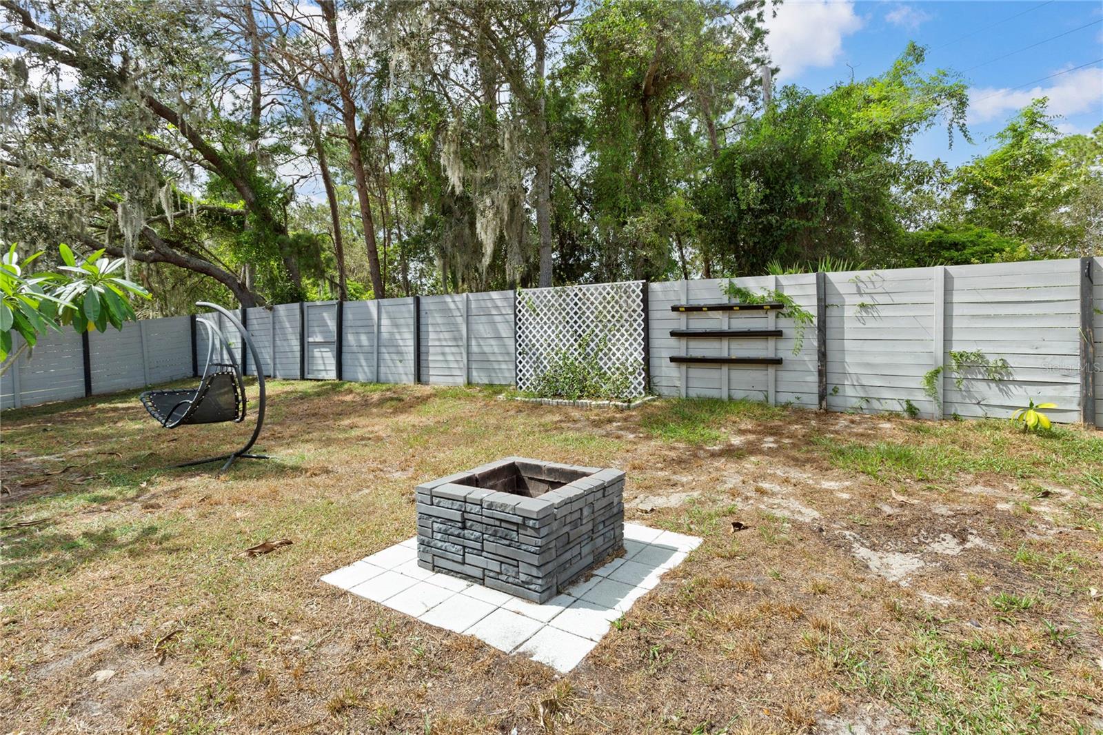 Fenced in Backyard with firepit
