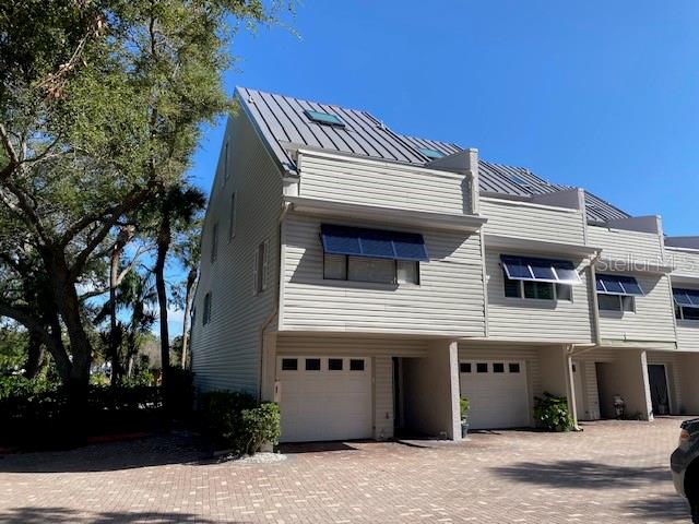 Exterior upgrades 2025 metal roof , motorized skylight and Bahama Shutters