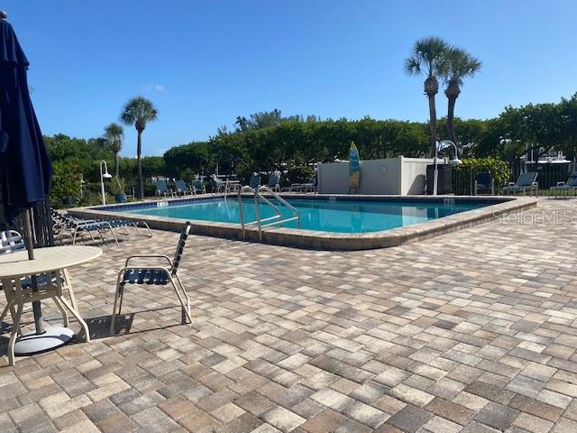 Waterside heated and cooled pool with custom surfboard shower