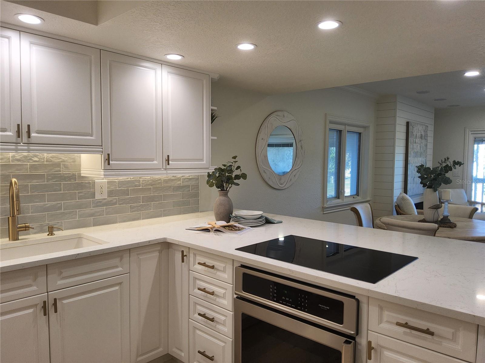 Kitchen with Bosch induction stovetop and brushed gold hardware