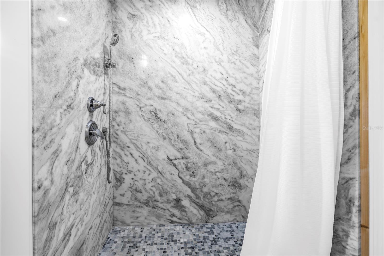Marble shower in the primary bath