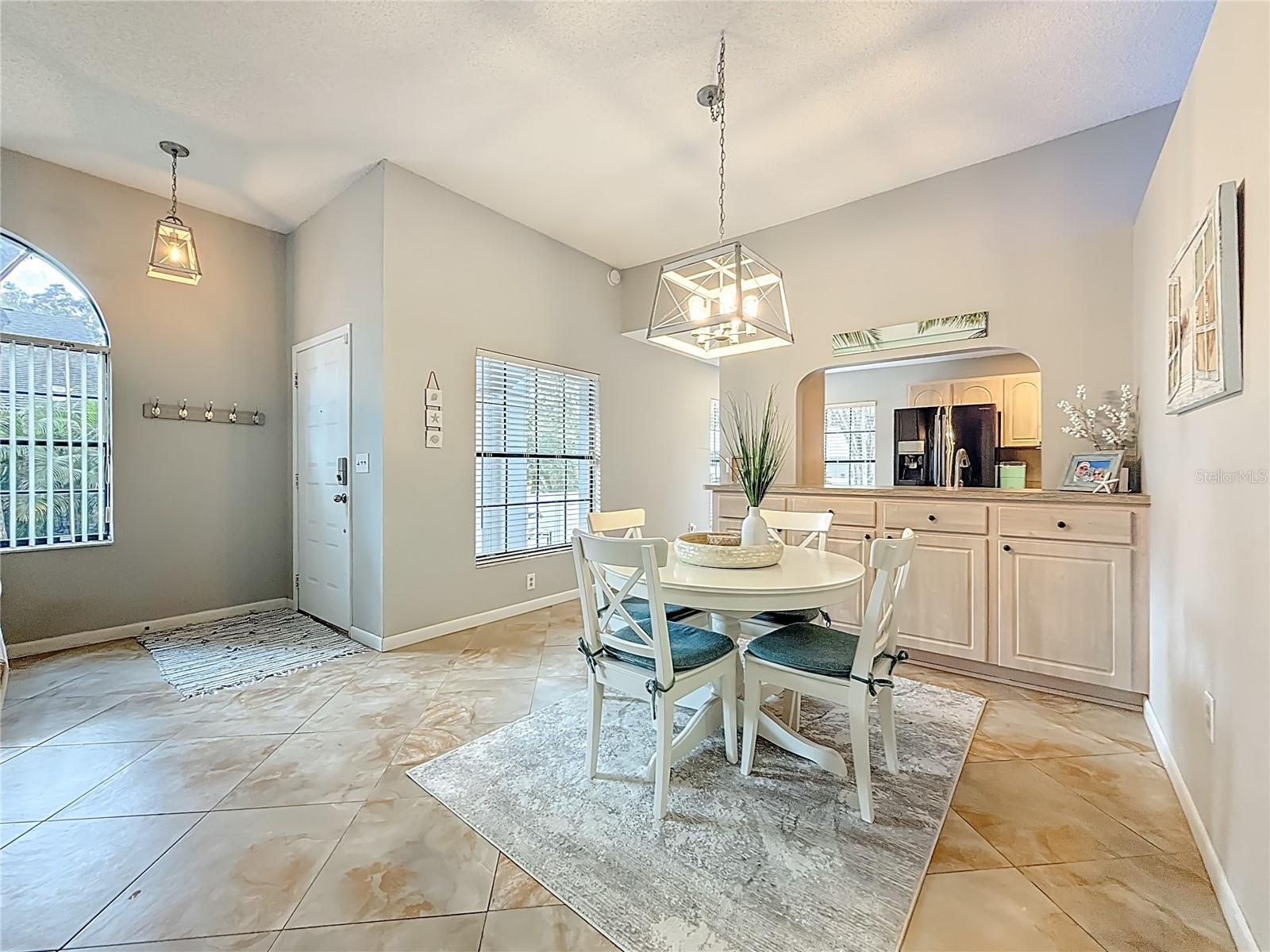 Dining Room Has Serving Counter and Cabinets