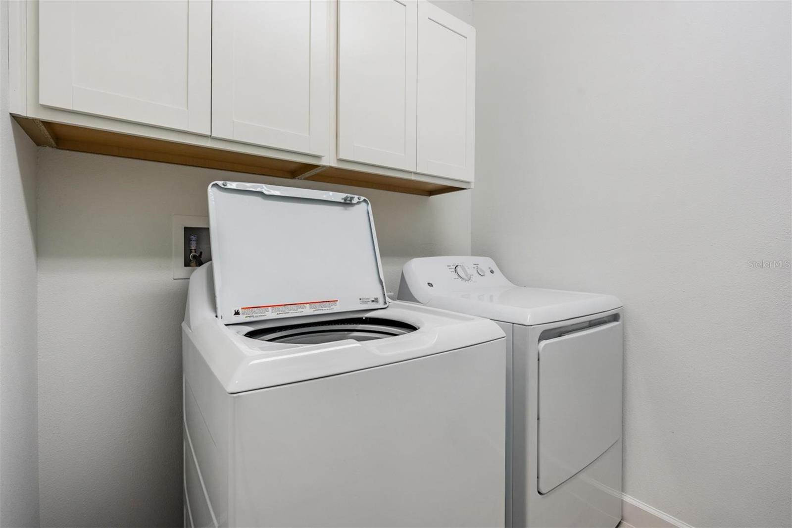 laundry room w/washer & dryer and cabinets