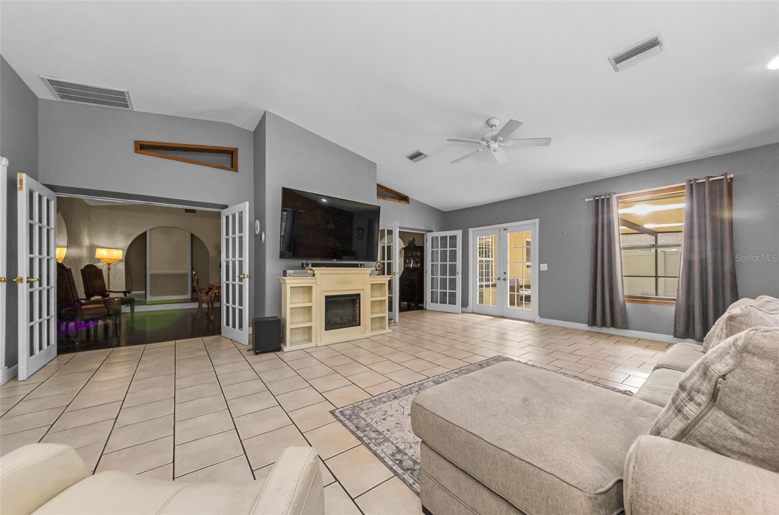 very large great room in the rear of the home overlooking the pool and patio