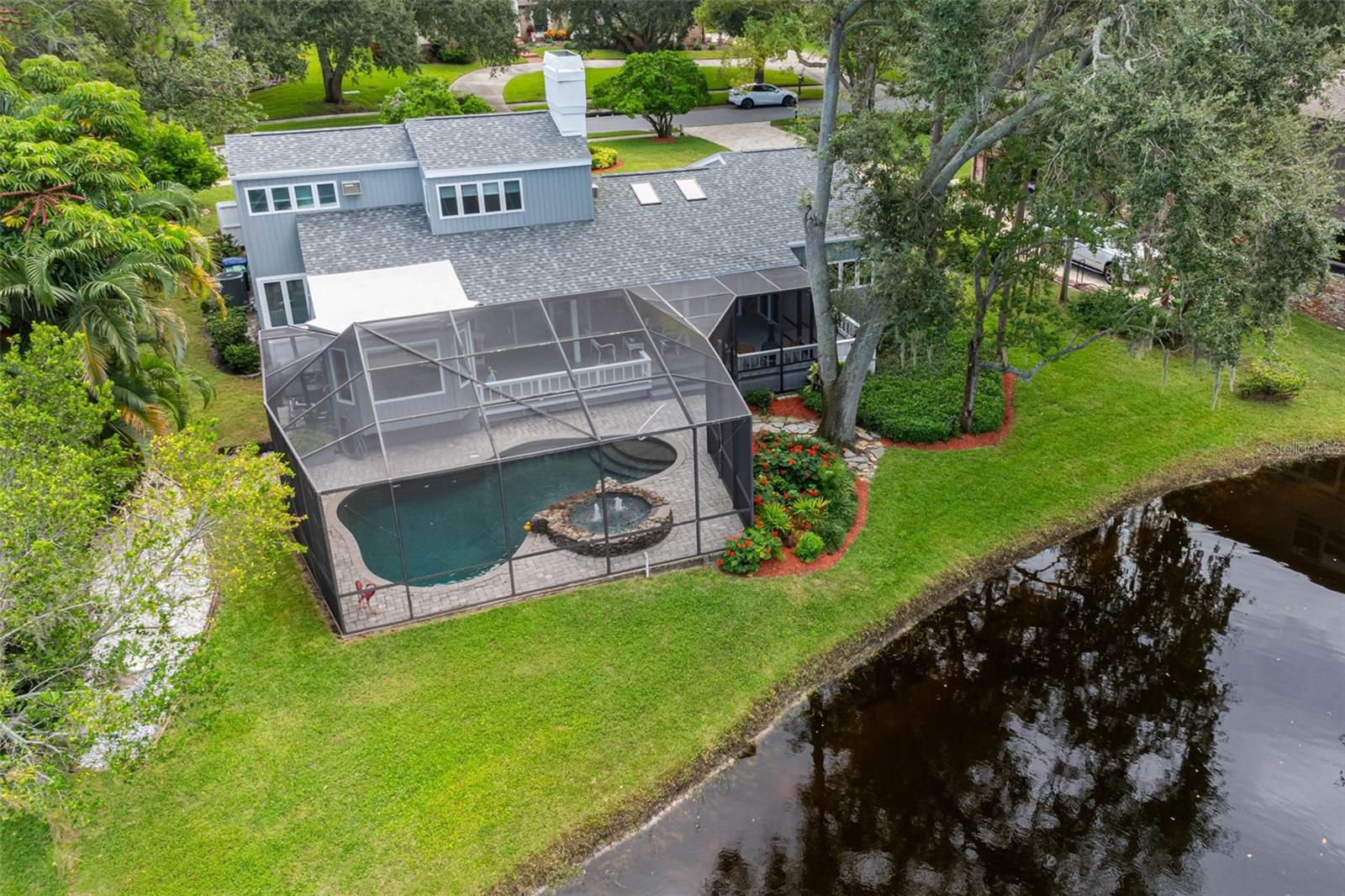 Large, covered Lanai overlooking pool and pond
