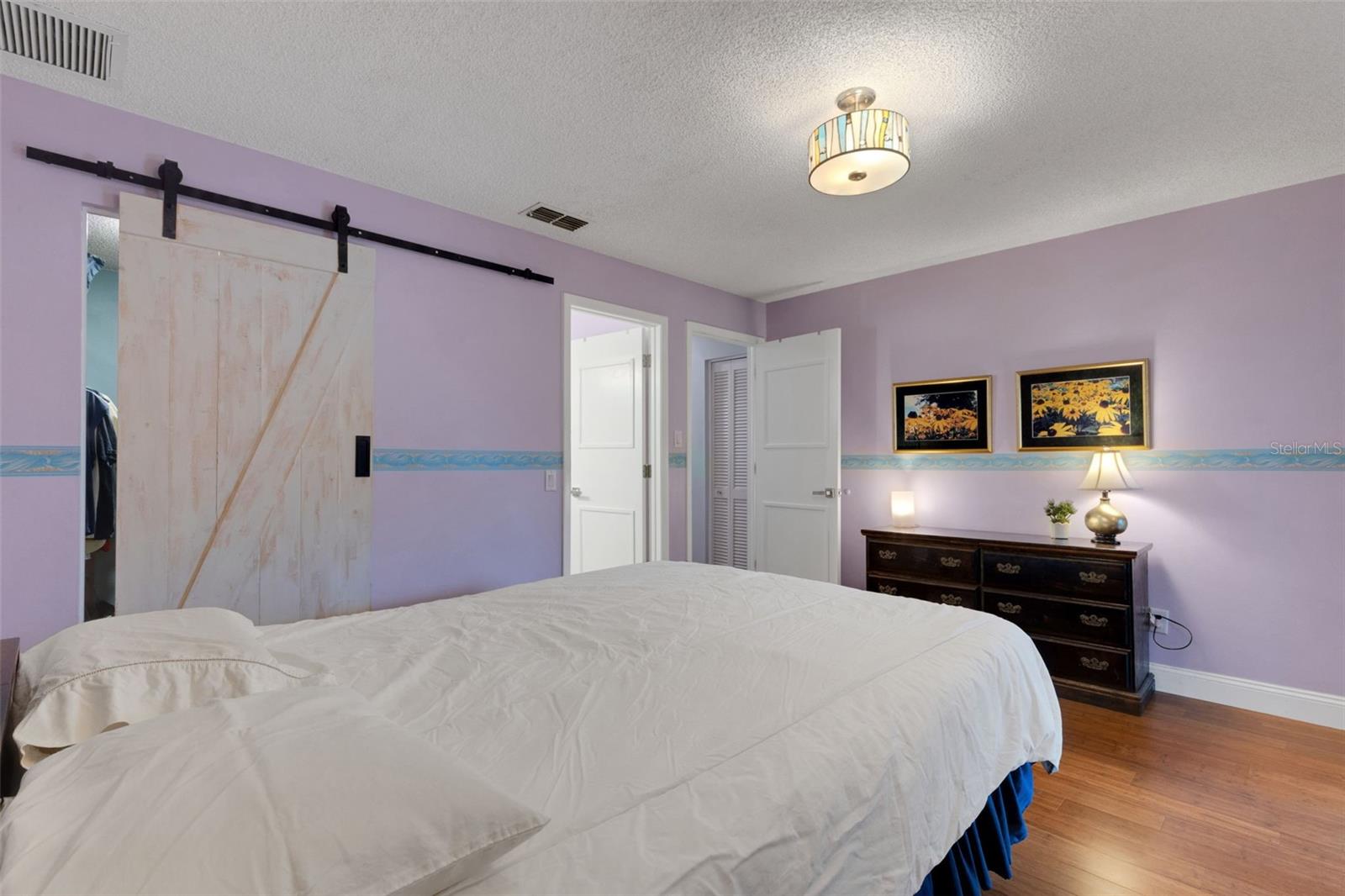 Large walk in closet with Stylist Barn door