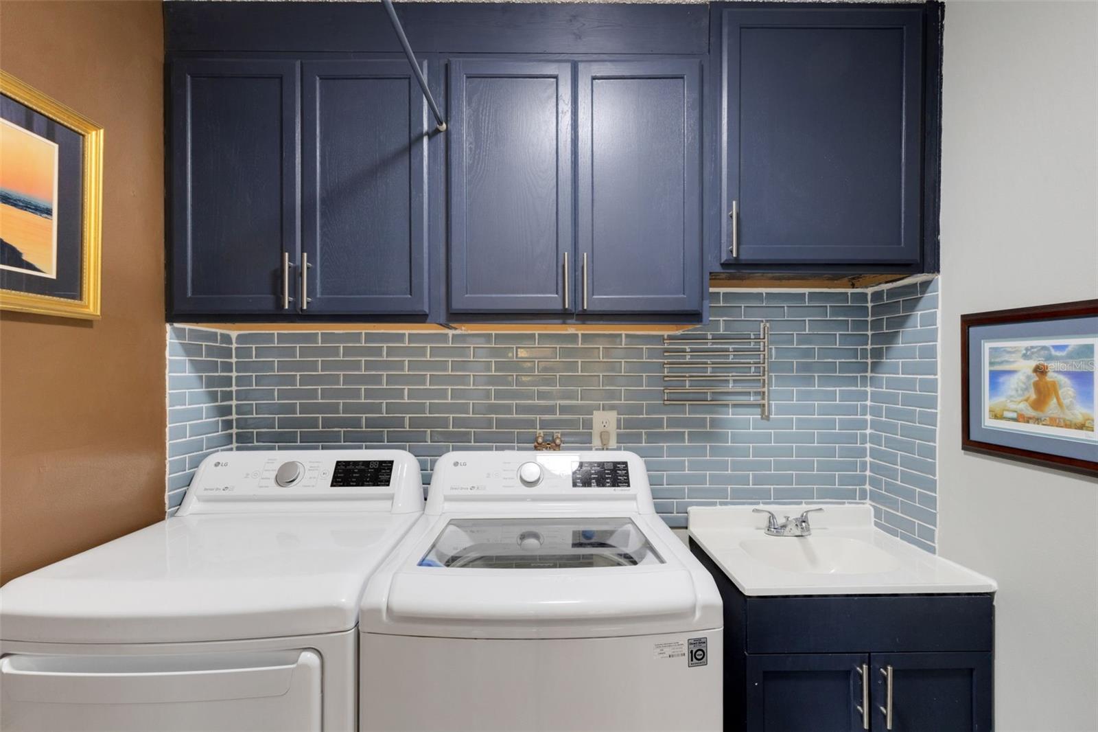 The Laundry room with utility sink is updated