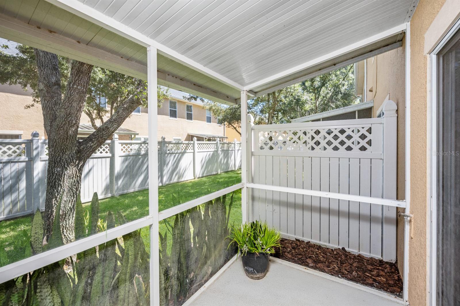 Screened-in patio with vinyl fence down the middle