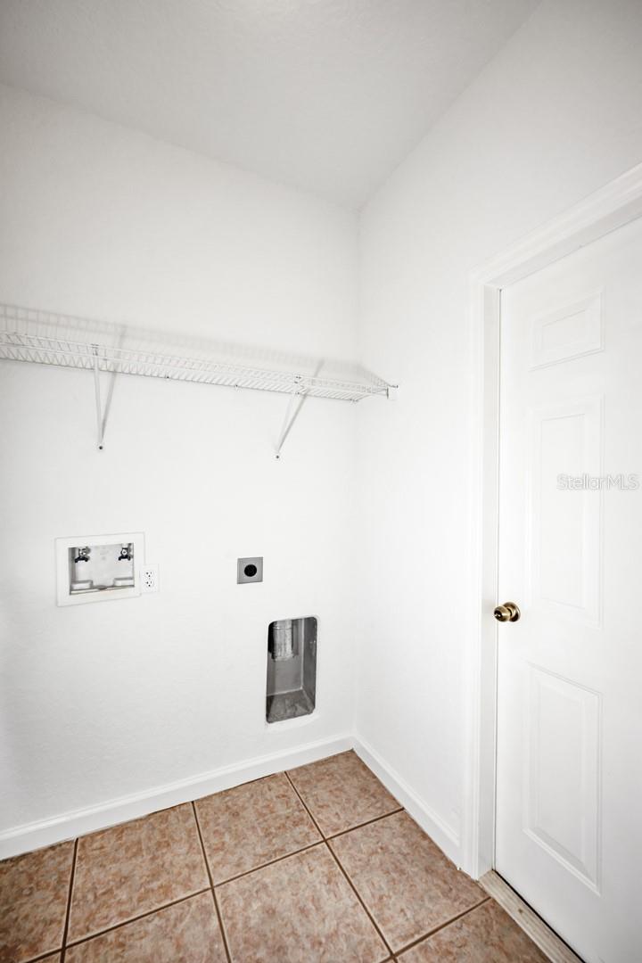 Laundry room leading into garage