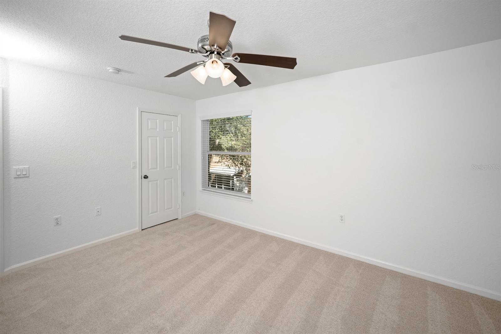 Primary bedroom with walk-in closet