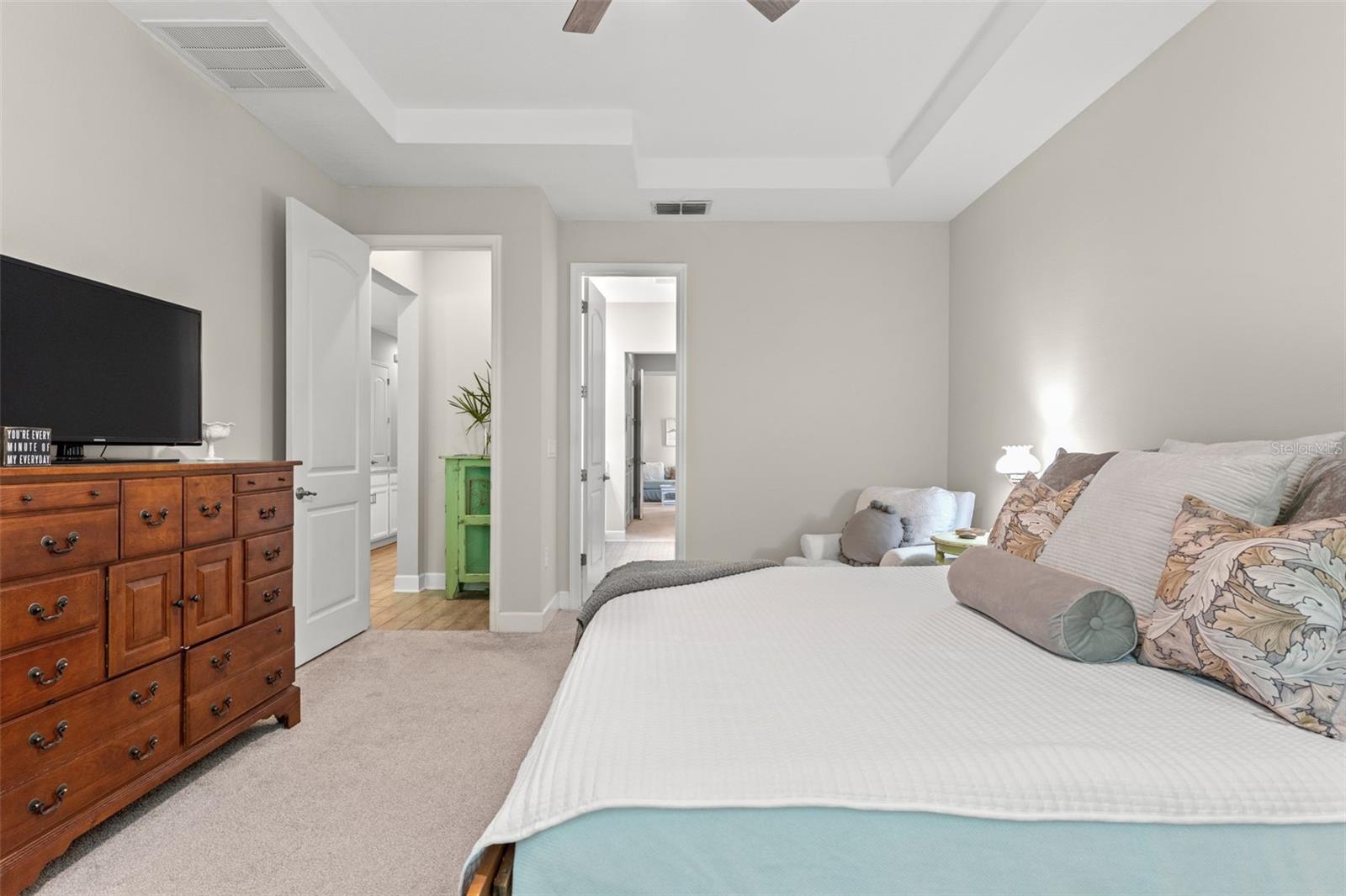 A comfortable layout with room for a sitting area or home workspace, connecting directly to the ensuite bath and walk-in closets.