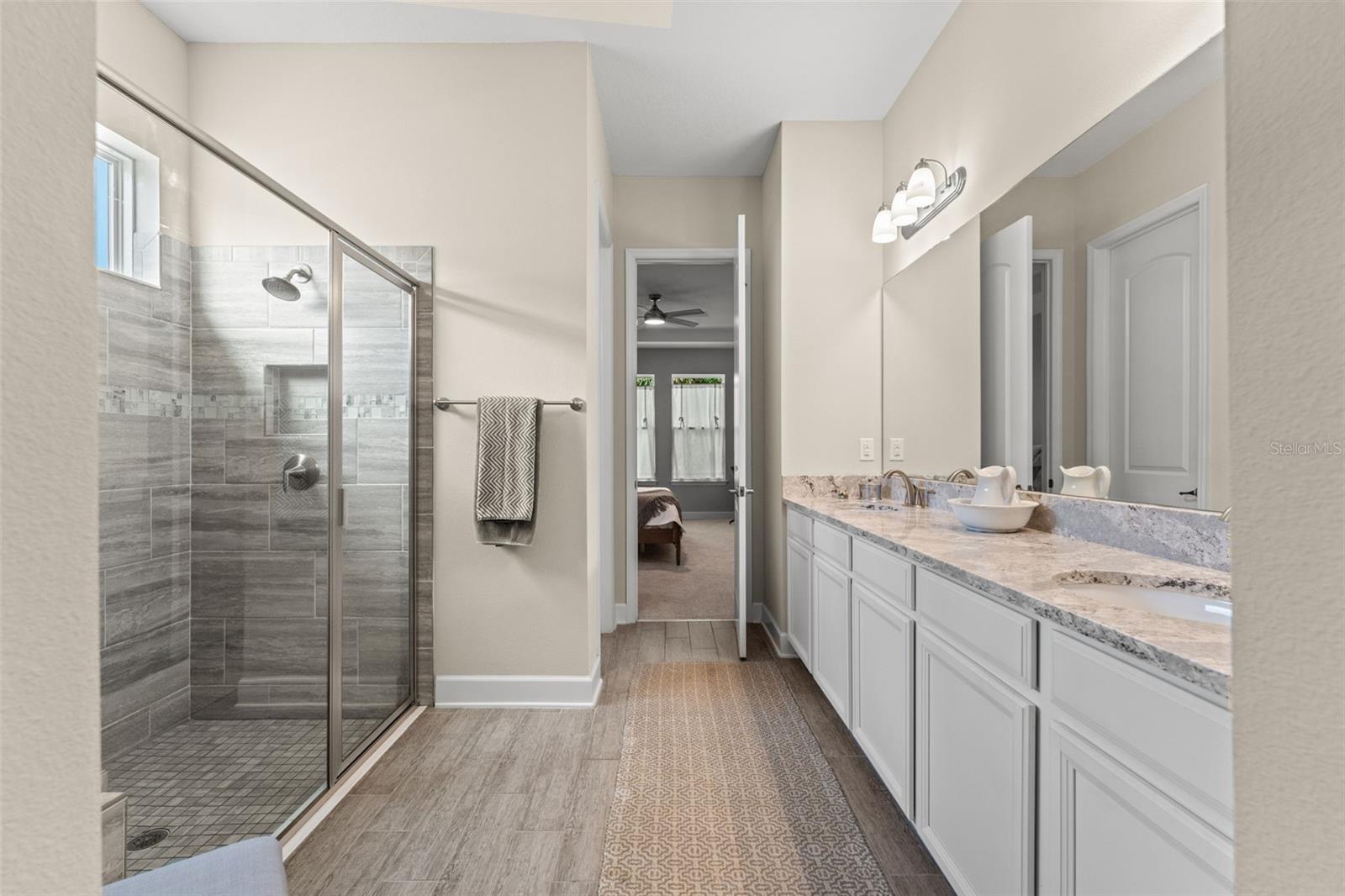 Spa-inspired walk-in shower with custom tilework and frameless glass enclosure, offering both style and relaxation.