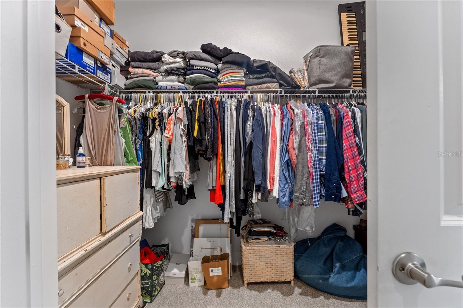 Exceptionally spacious walk-in closet with abundant hanging and shelving space for optimal organization.