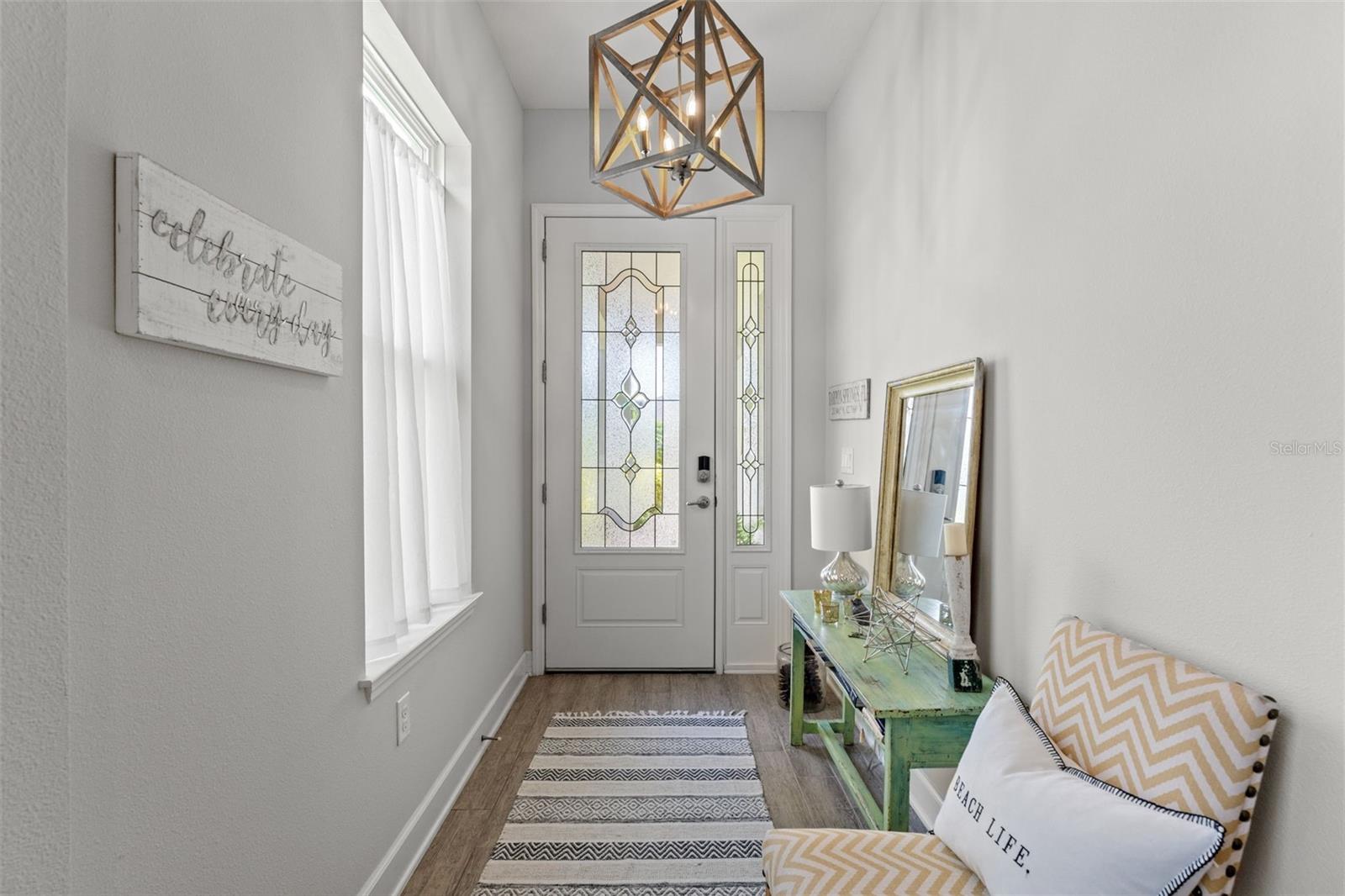 Light-filled entrance with coastal accents and stylish décor creates a warm first impression as you step inside.