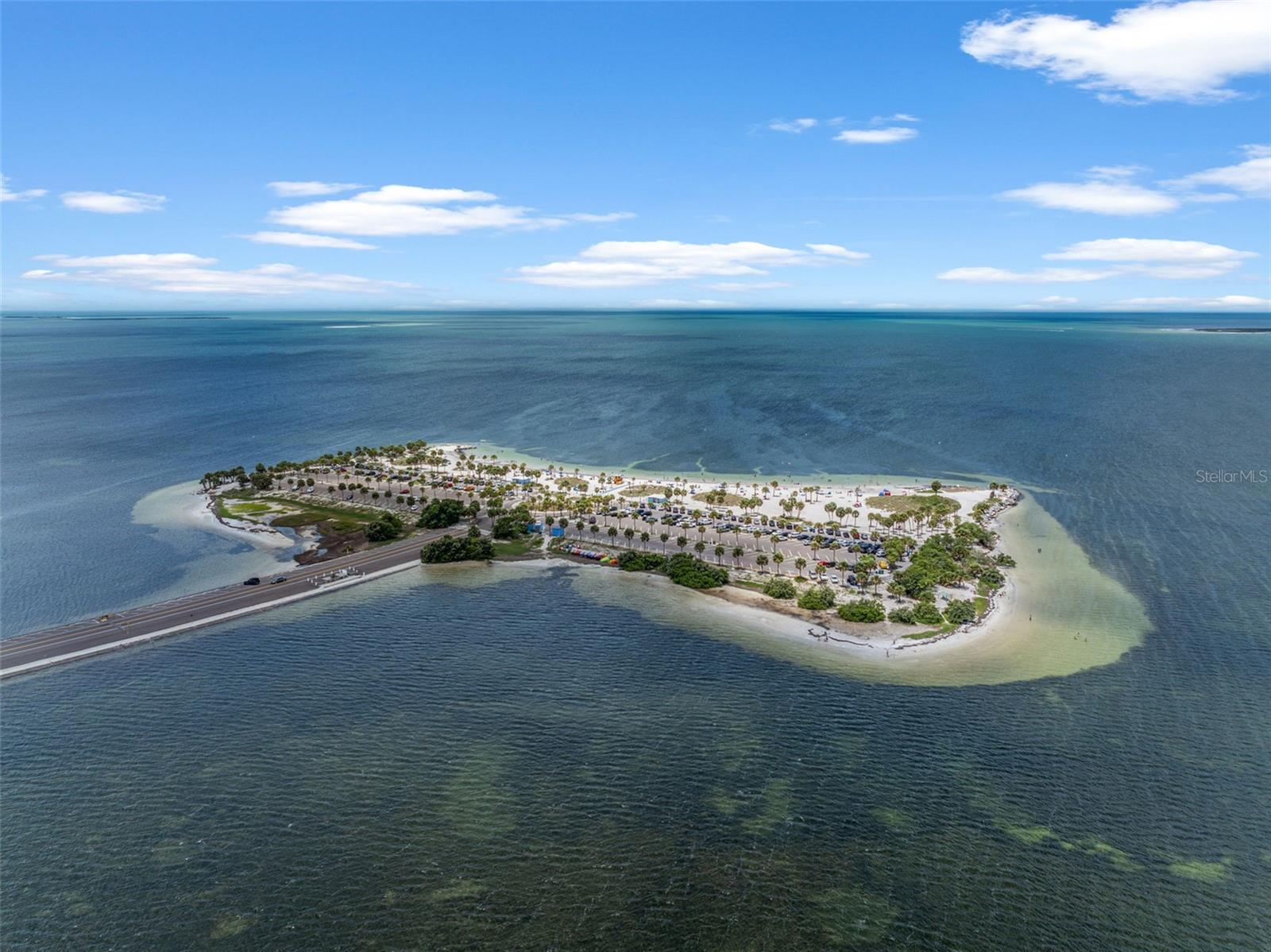 Stunning overhead perspective of the nearby beach and causeway—just a short drive from the home.