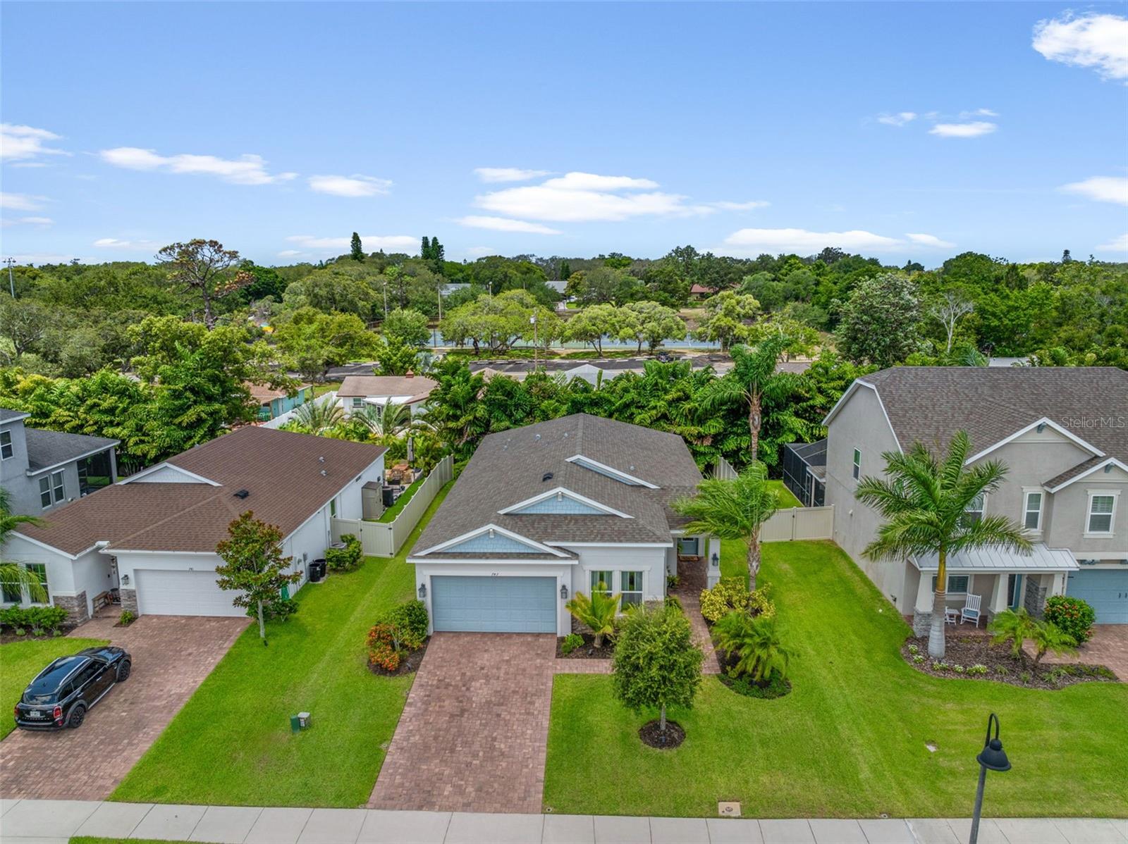 Shows the home’s pristine curb appeal, manicured lawn, and quiet Bayshore Heights street.
