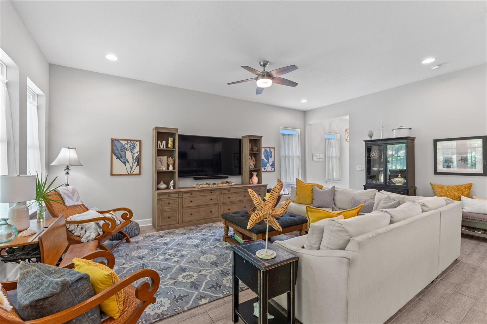 Stylish and inviting, this bright living space features designer details and a layout that maximizes comfort and connection.