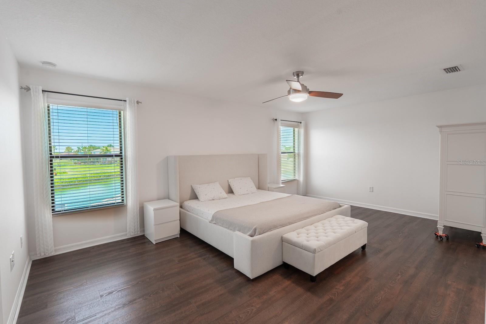 Large, spacious primary suite featuring beautiful views of the pool and the pond.