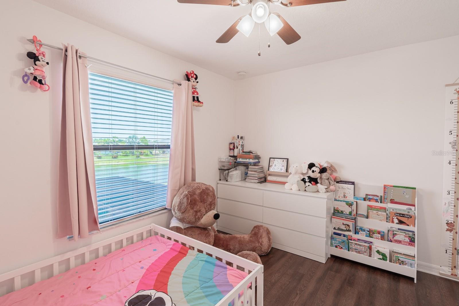 Bedroom 2, which offers a scenic view overlooking the pool and pond.