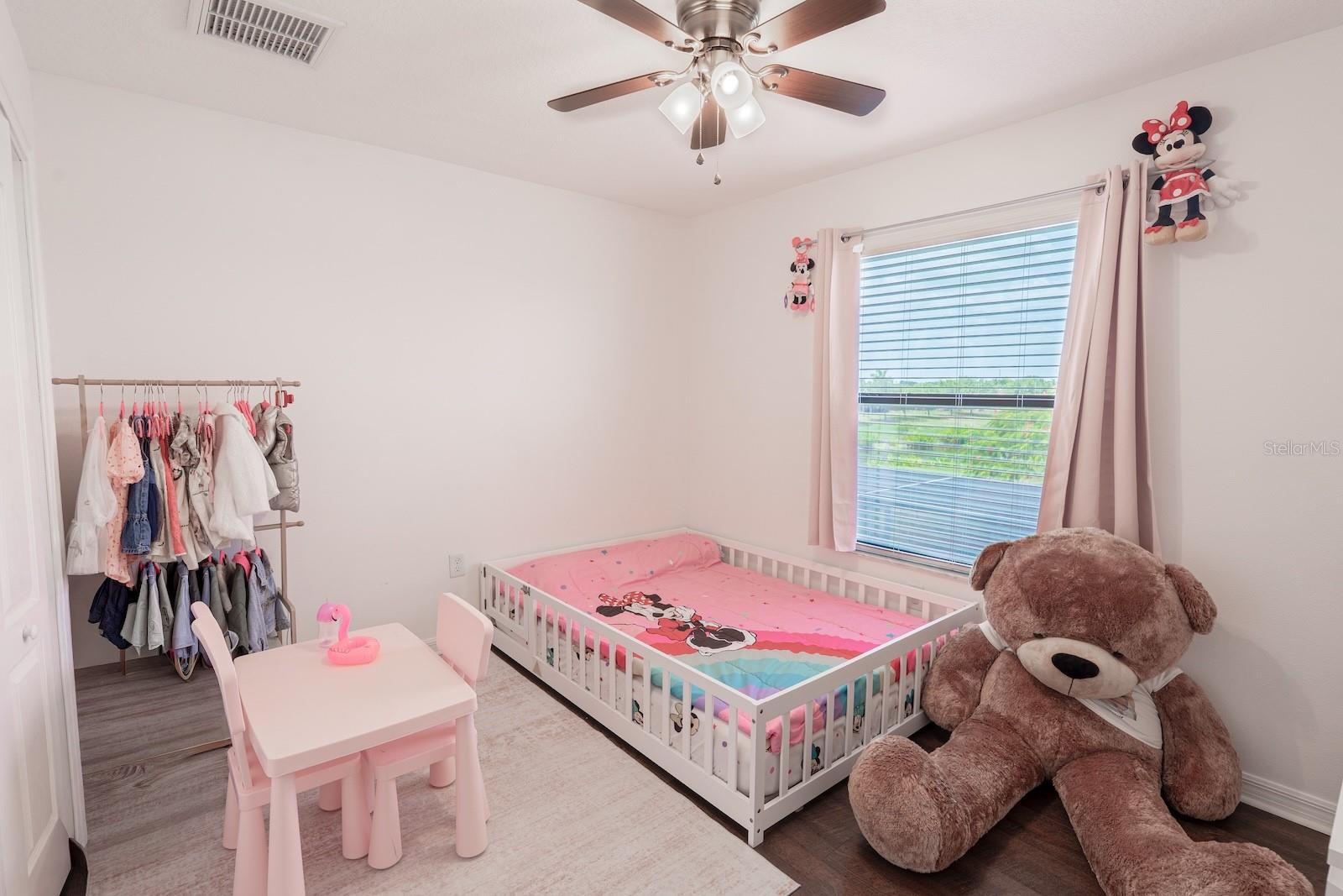 Bedroom 2, which offers a scenic view overlooking the pool and pond.
