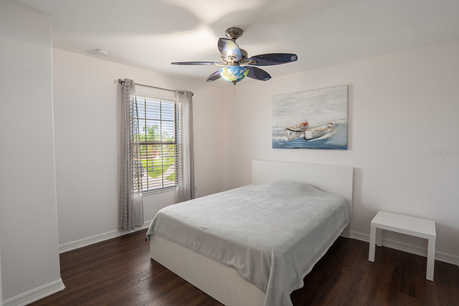 Spacious fourth bedroom featuring neutral finishes, perfect for use as a guest room, home office, or hobby space.