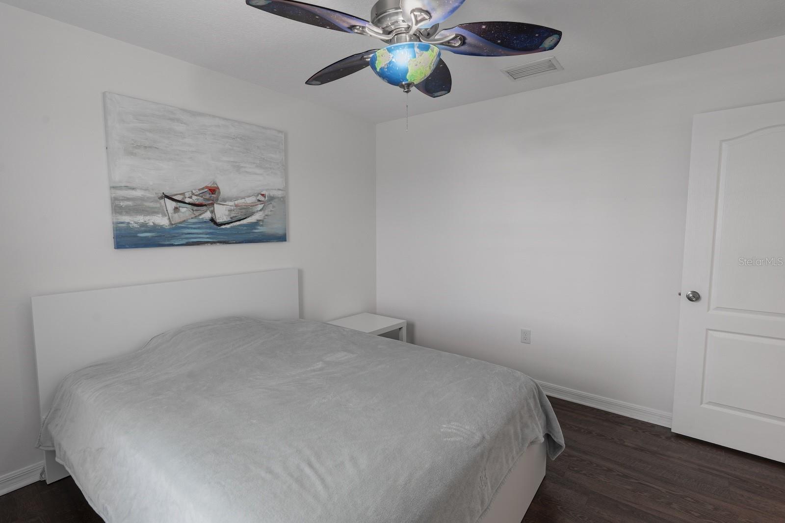 Spacious fourth bedroom featuring neutral finishes, perfect for use as a guest room, home office, or hobby space.