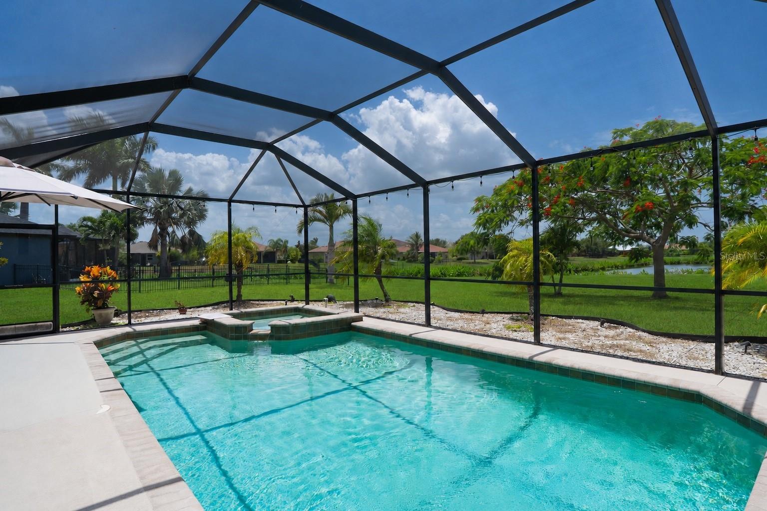 Stunning views of the trees and pond, visible directly from the pool area.