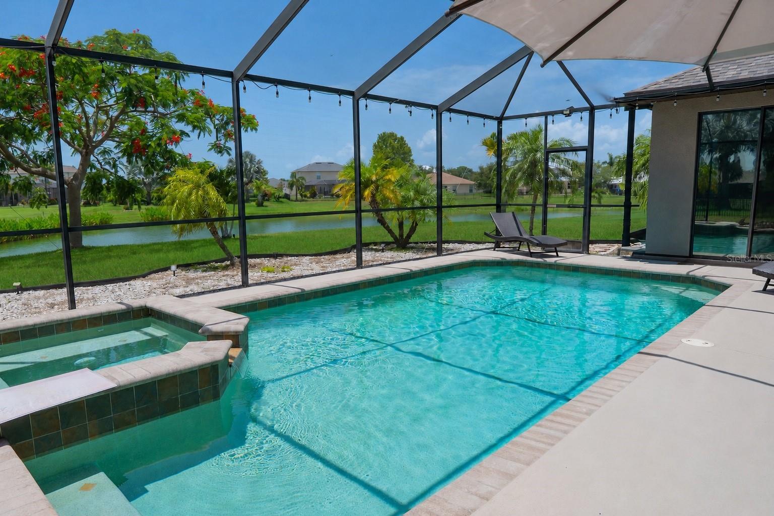 Stunning views of the trees and pond, visible directly from the pool area.