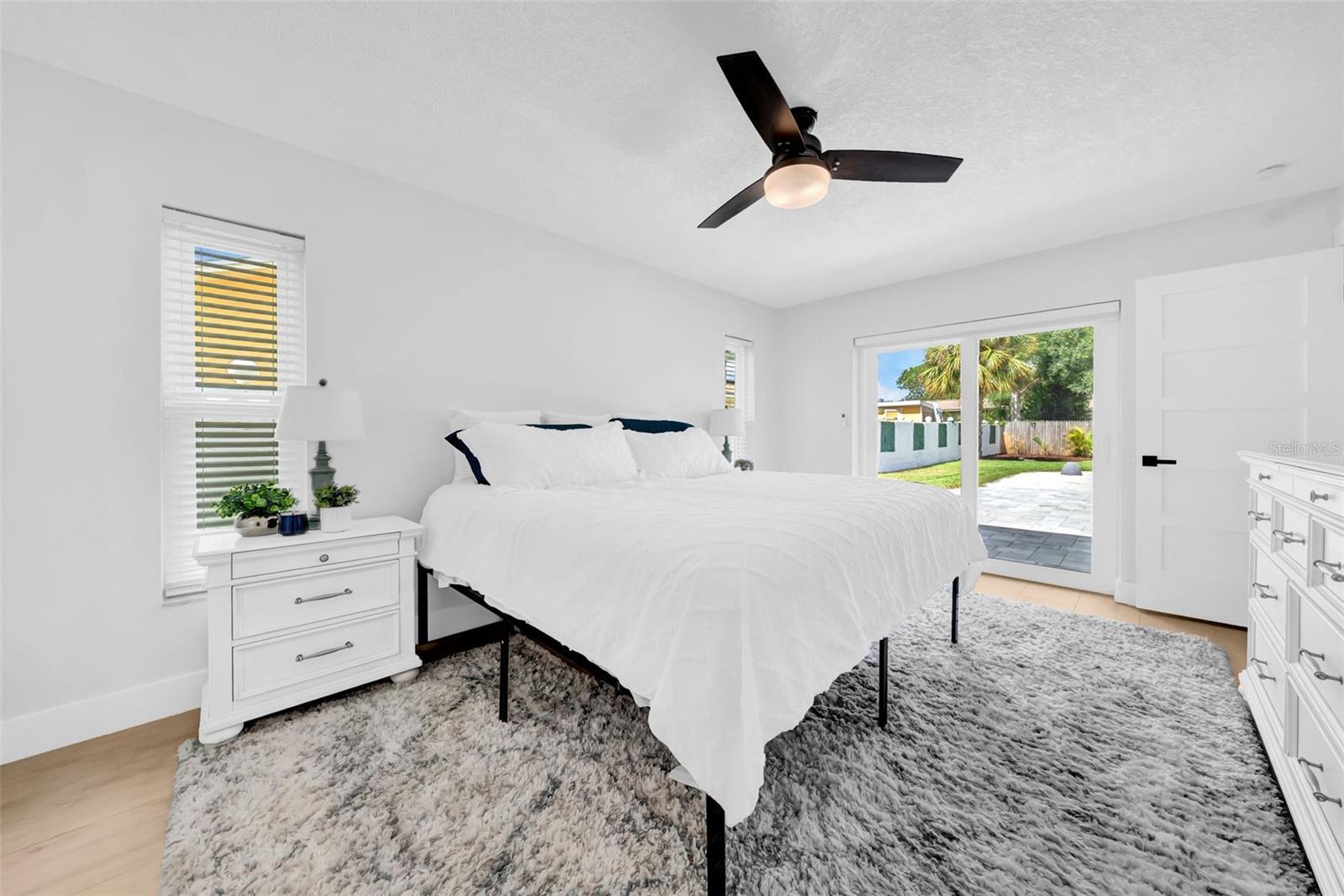Primary bedroom with sliders going to the pool.