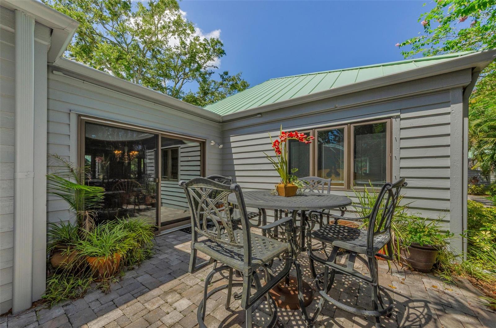 Back patio off the den and kitchen area. So easy for entertaining! Check out the new metal roof! 2025