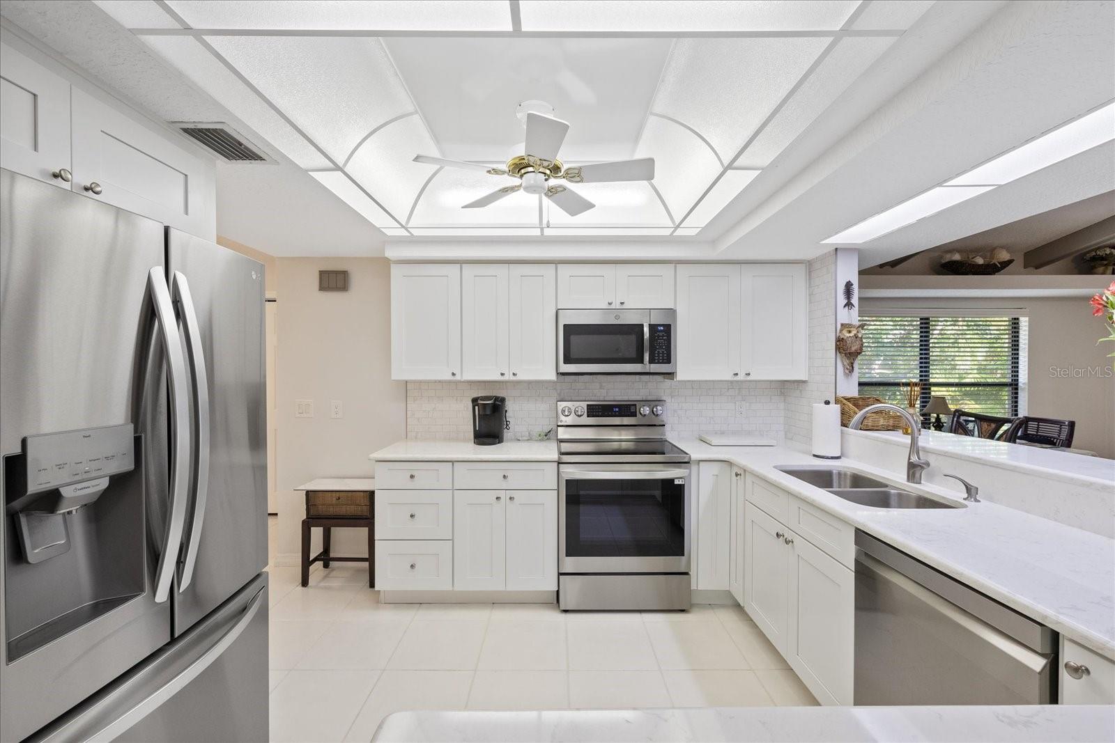 Quartz countertops and NEW Appliances and cabinets in light bright kitchen
