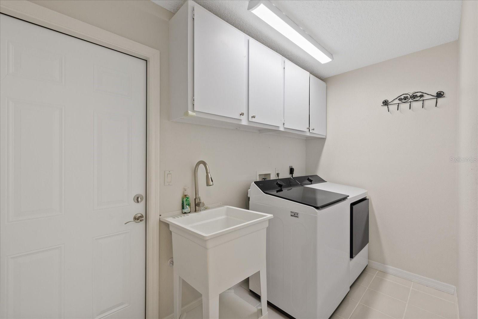 Laundry room with new sink, washer/dryer
