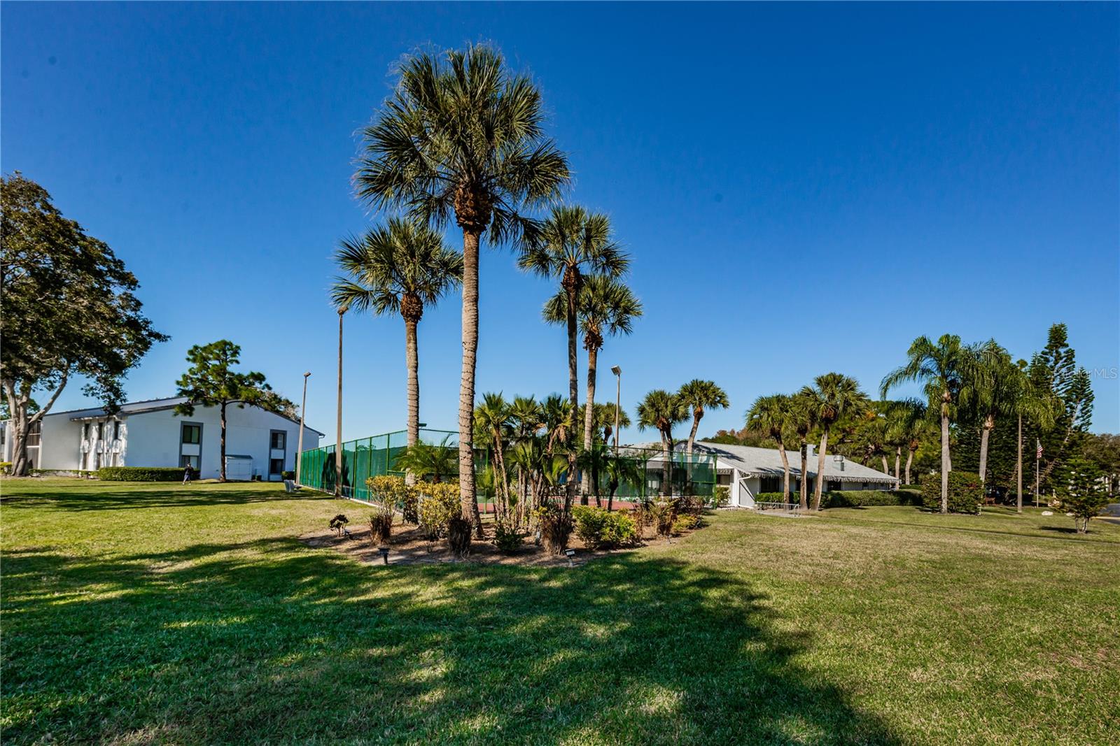 Building is next to tennis court & pool