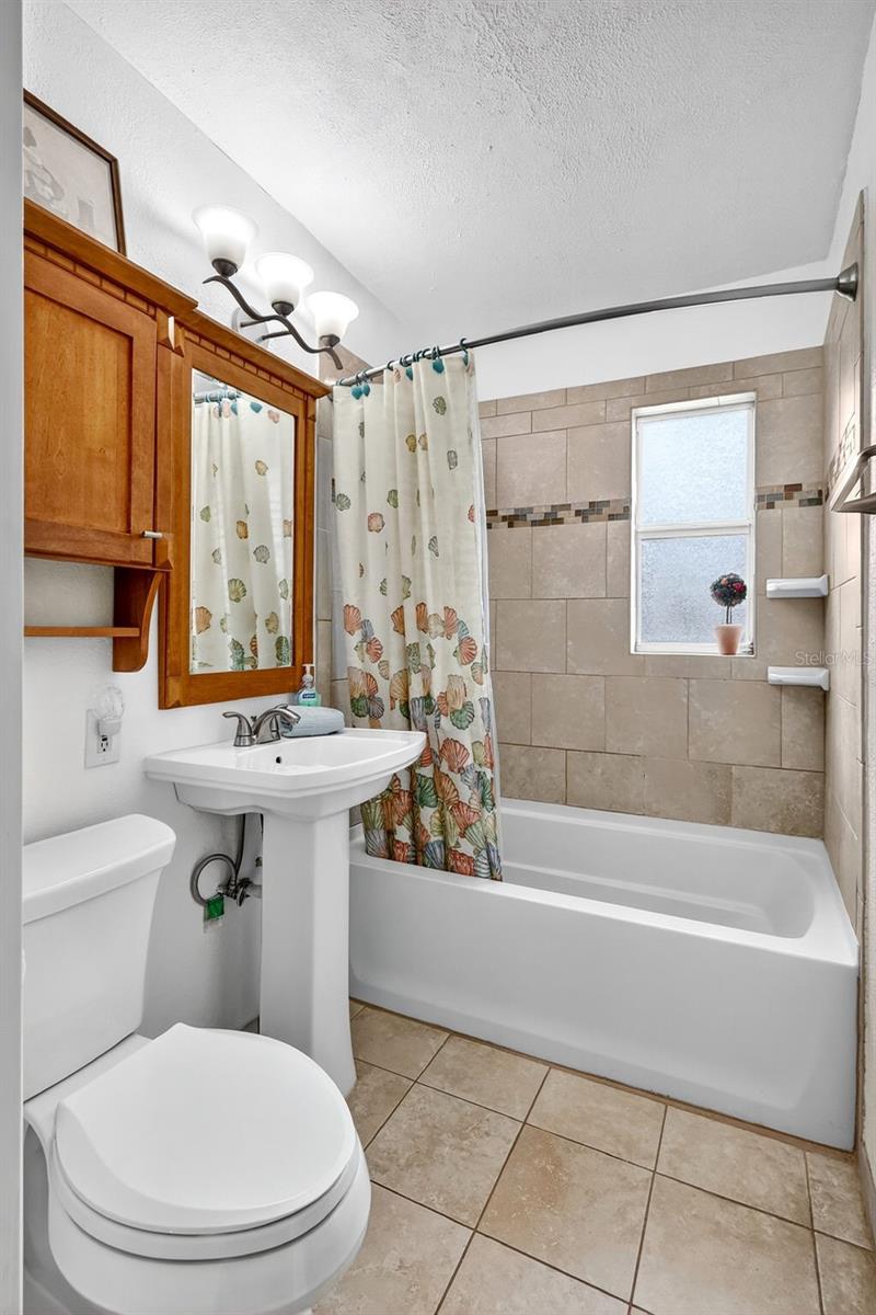 Neutral bathroom has been updated and includes a storage closet niche, plus a nearby hall linen closet.