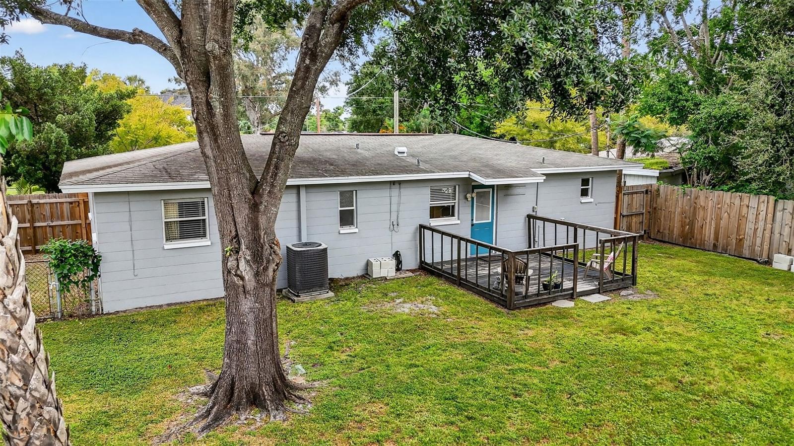 Large fenced back yard with a deck, shade tree and a separately fenced side yard, great for a garden or a dog run.
