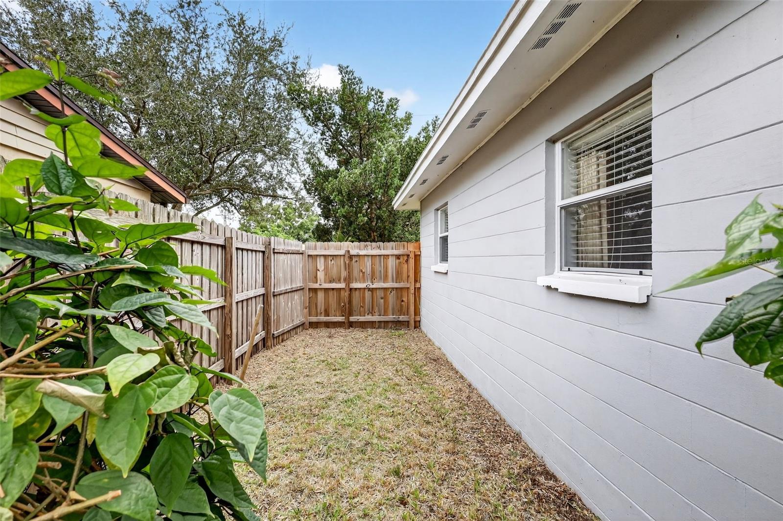 Side yard with separate entry fence at back yard; great for a dog run or garden area.