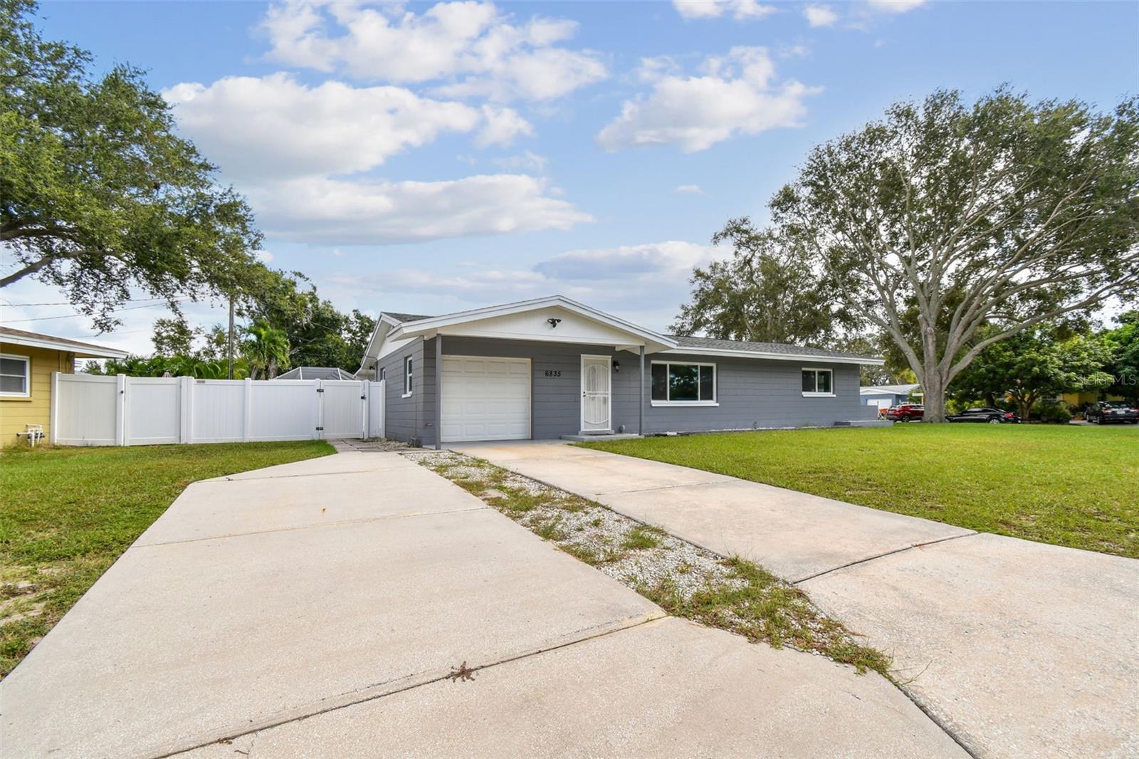 One car garage with auto-door, and double parking pads