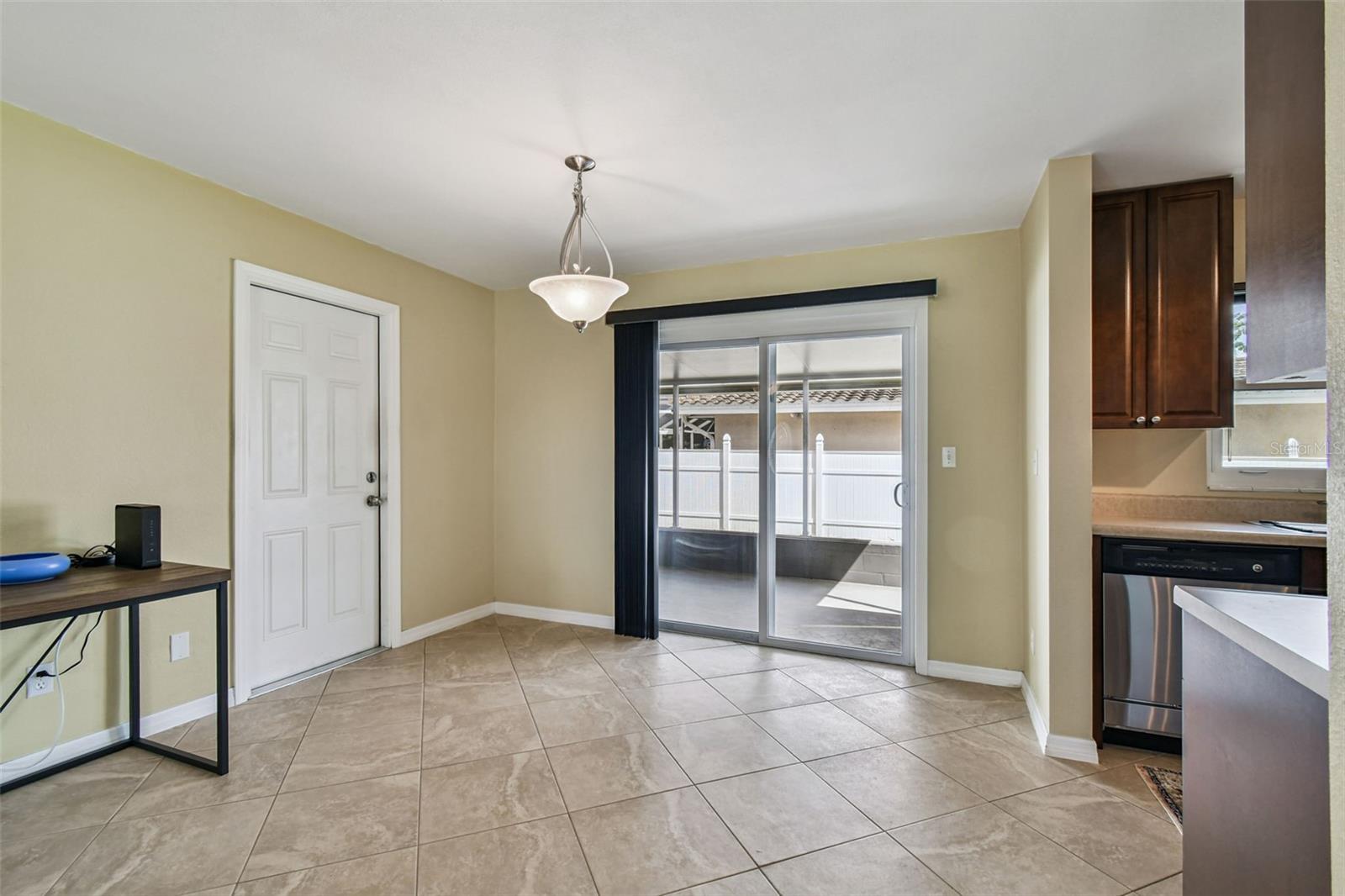 Dining Area, sliders to screened back patio.