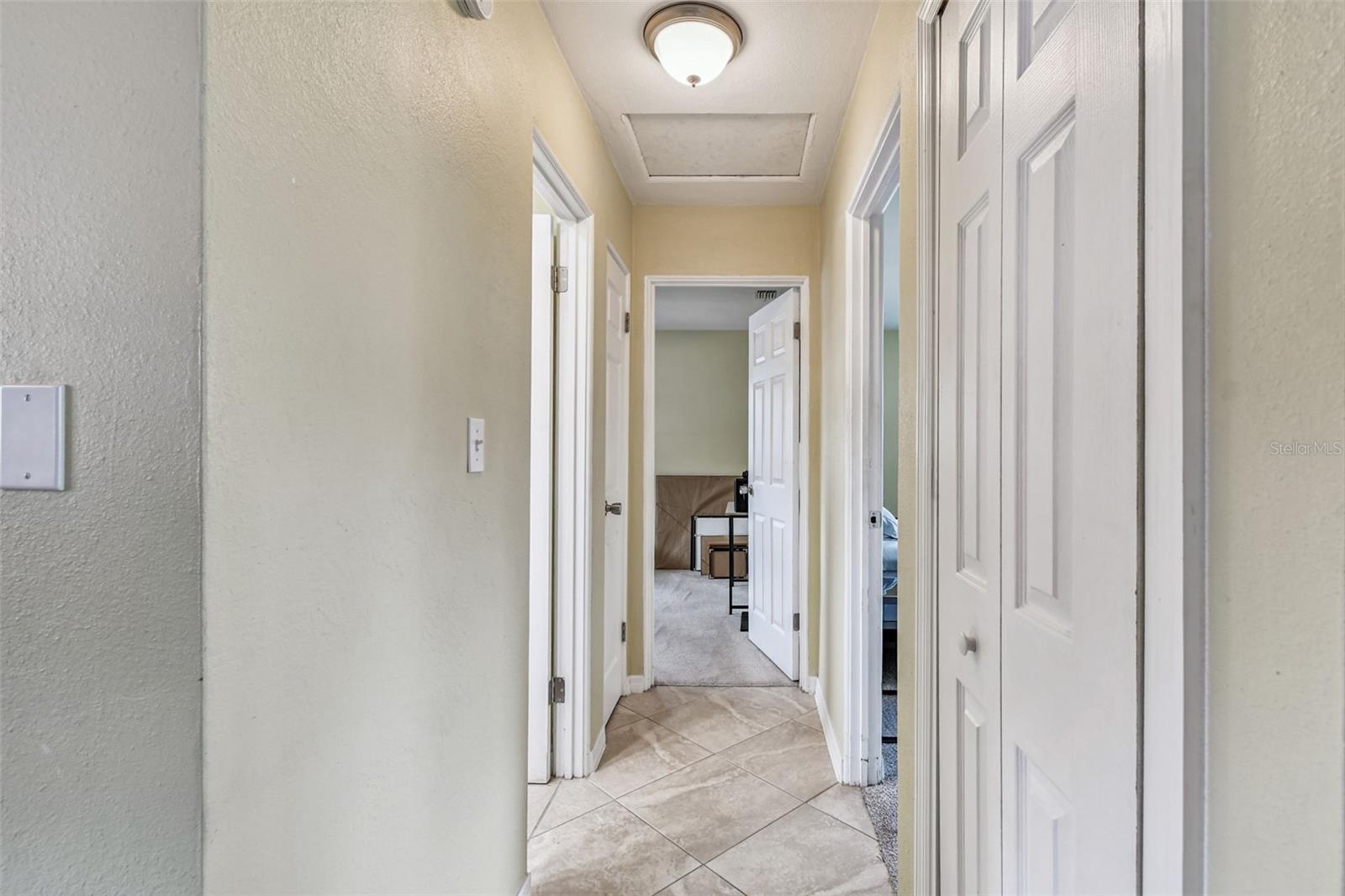 Hallway to bedrooms and bathroom. 6 panel doors throughout.