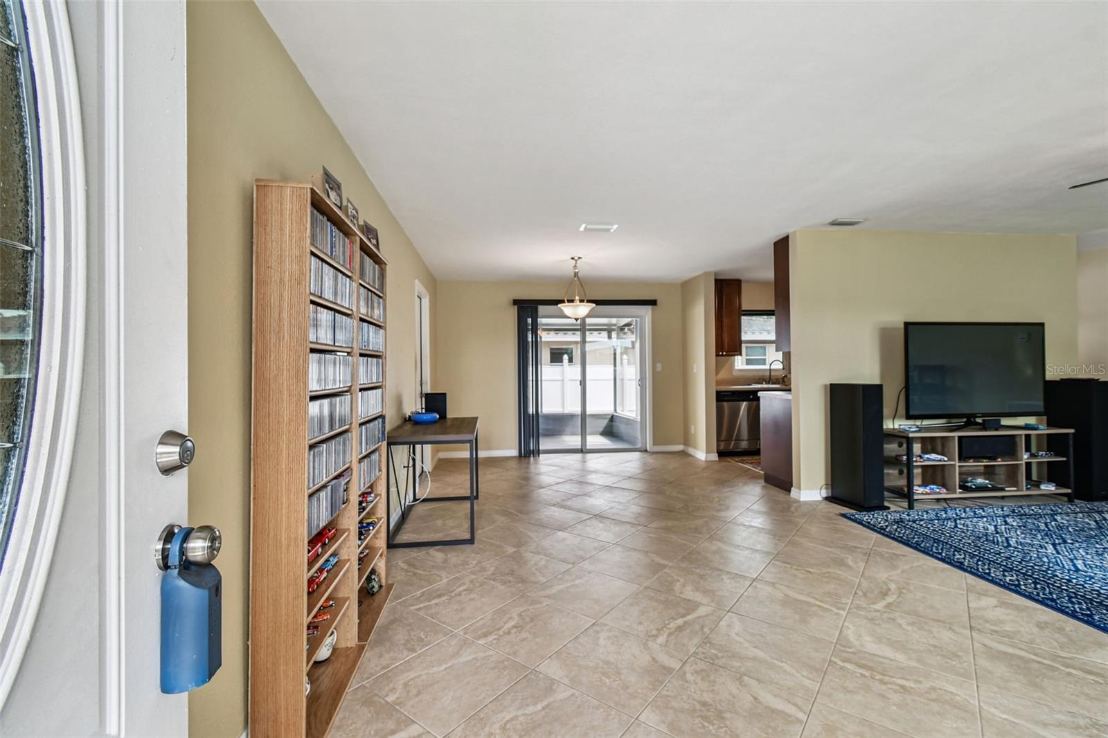 At entry. Sliders to screened enclosed back patio