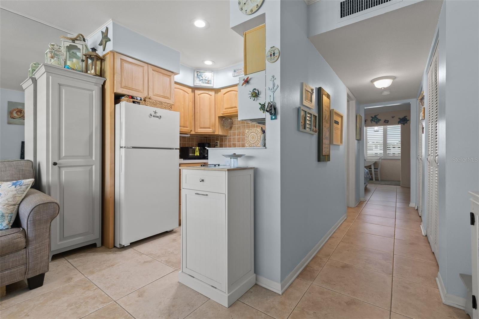 Hallway between living room and bedroom, storage/pantry closets on the side