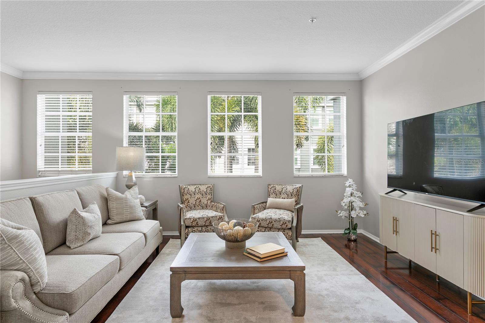 Located on the second level, the spacious living room flows seamlessly into the kitchen, which features a convenient dry bar and a space for a dining area—perfect for both everyday living and entertaining.