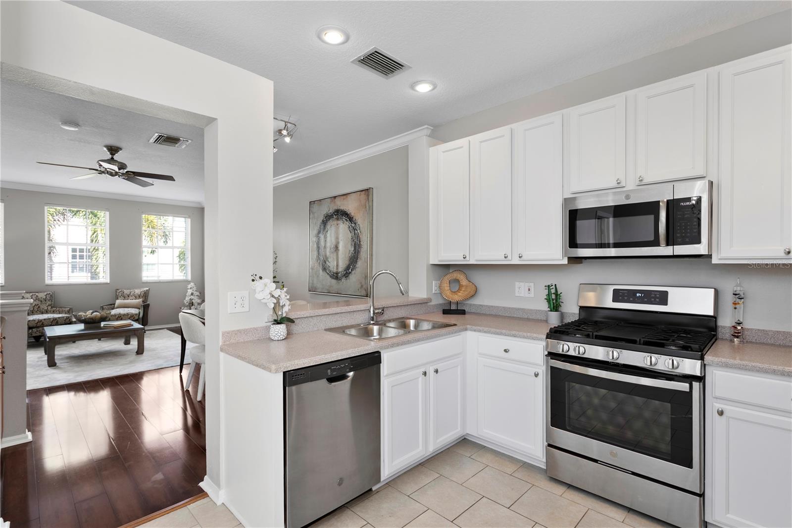 The well-appointed eat-in kitchen featuring abundant cabinetry and prep space and stainless steel appliances