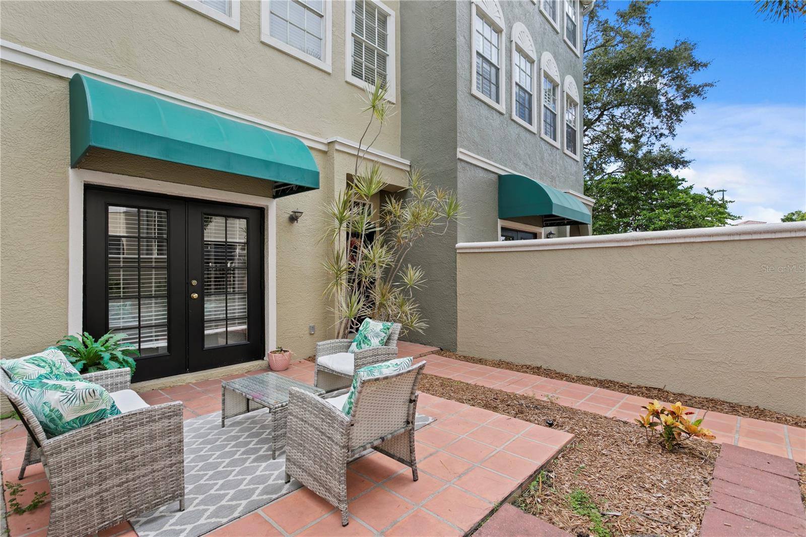 Step through the gated entry into your private courtyard — a lush, sun-drenchedretreat ideal for entertaining, gardening, or unwinding with a glass of wine.