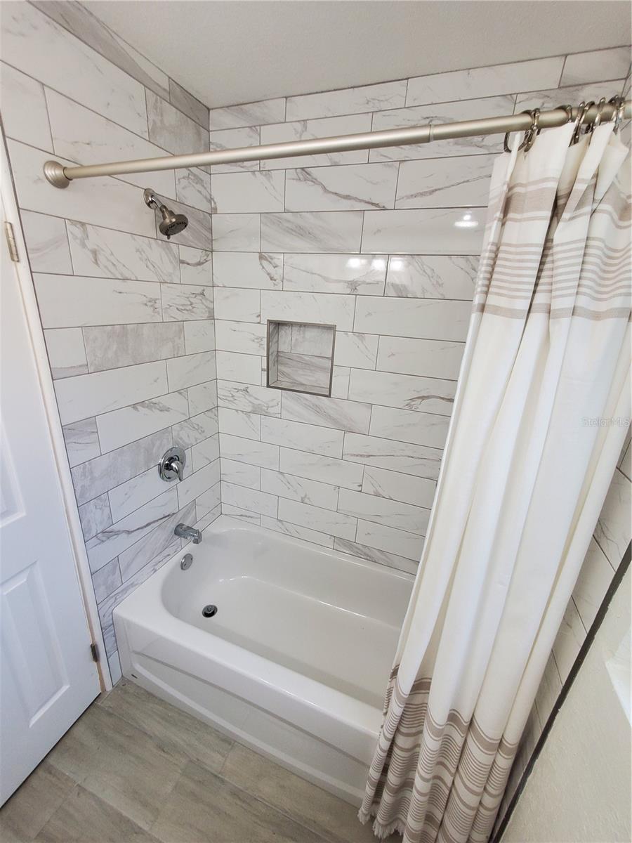 NEW TUB AND WALL TILE.