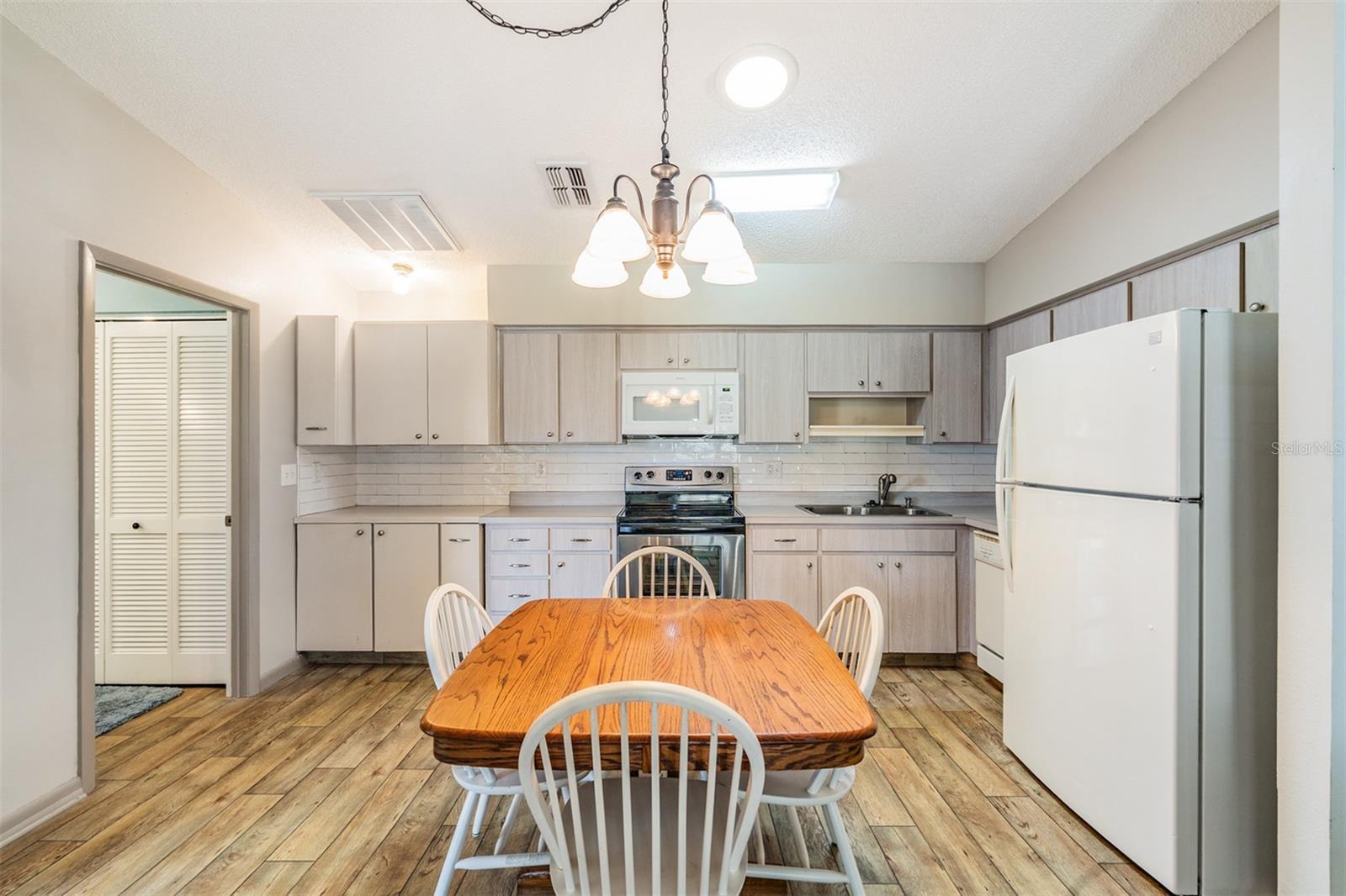 Open Kitchen, High Ceilings, lots of counter top space, dishwasher, range, refrigerator and microwave.