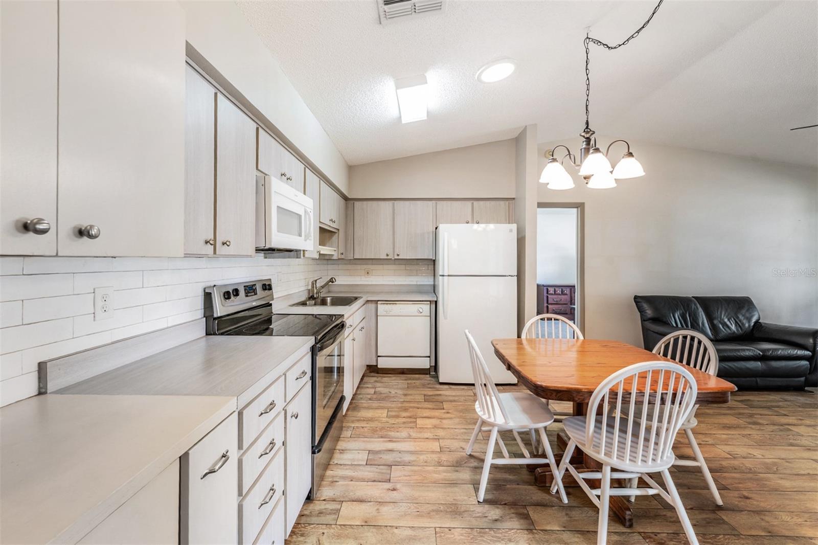 Open Kitchen, High Ceilings, lots of counter top space, dishwasher, range, refrigerator and microwave.