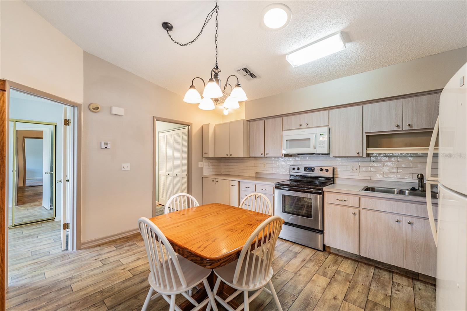 Open Kitchen, High Ceilings, lots of counter top space, dishwasher, range, refrigerator and microwave.