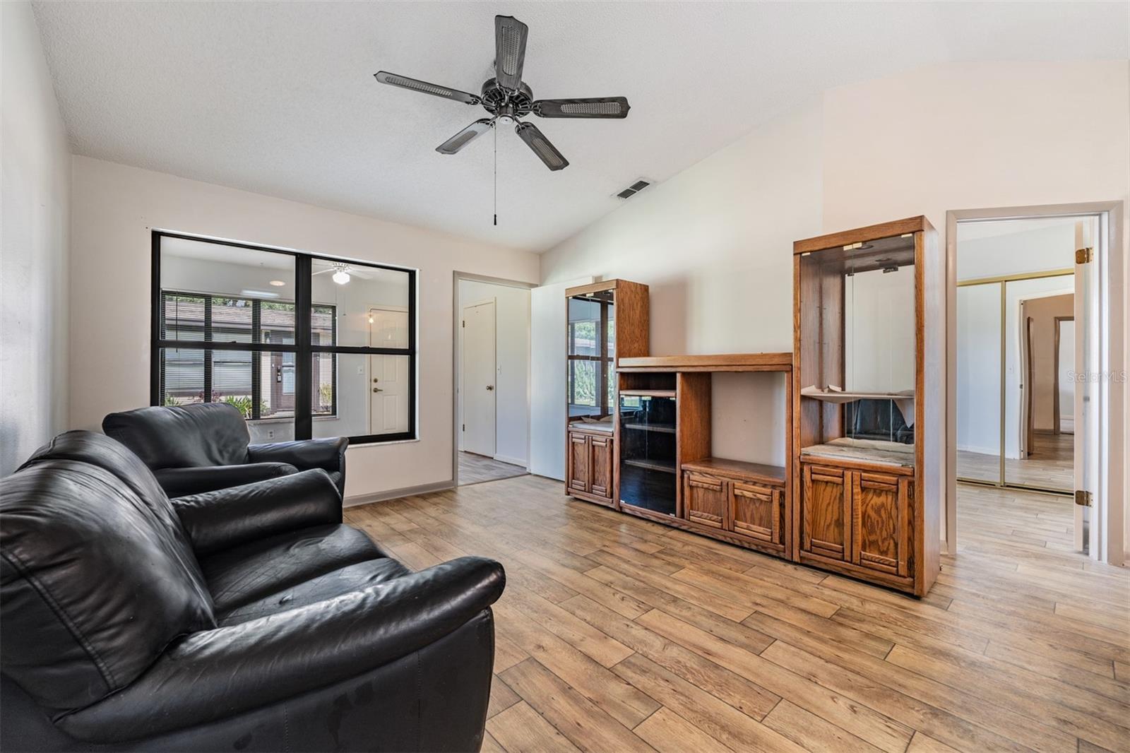 amily Room, just inside of the Florida Room, Laminate Flooring, high ceilings and ceiling fan.